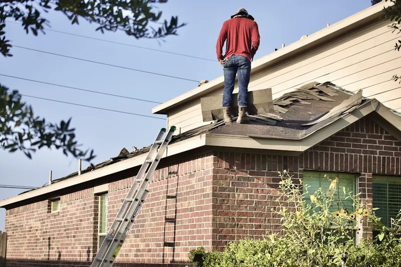 Professional roofer working on a residential roof in Verga